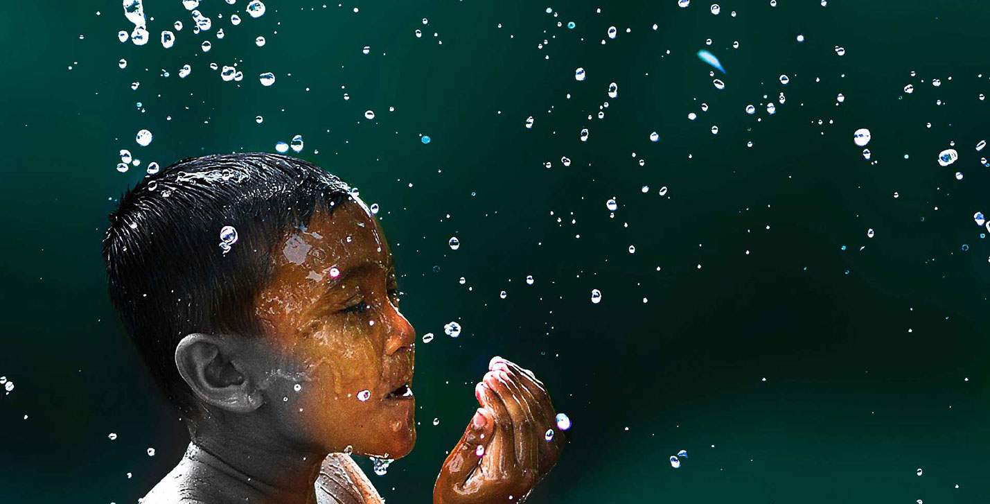 Treadright foundation slider image of a little boy splashing water on his face