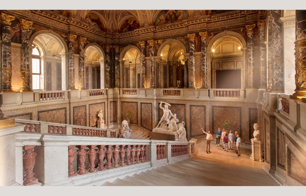 An ornate building with statues and a staircase.