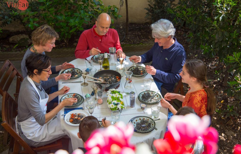 A group of people sitting around a table.