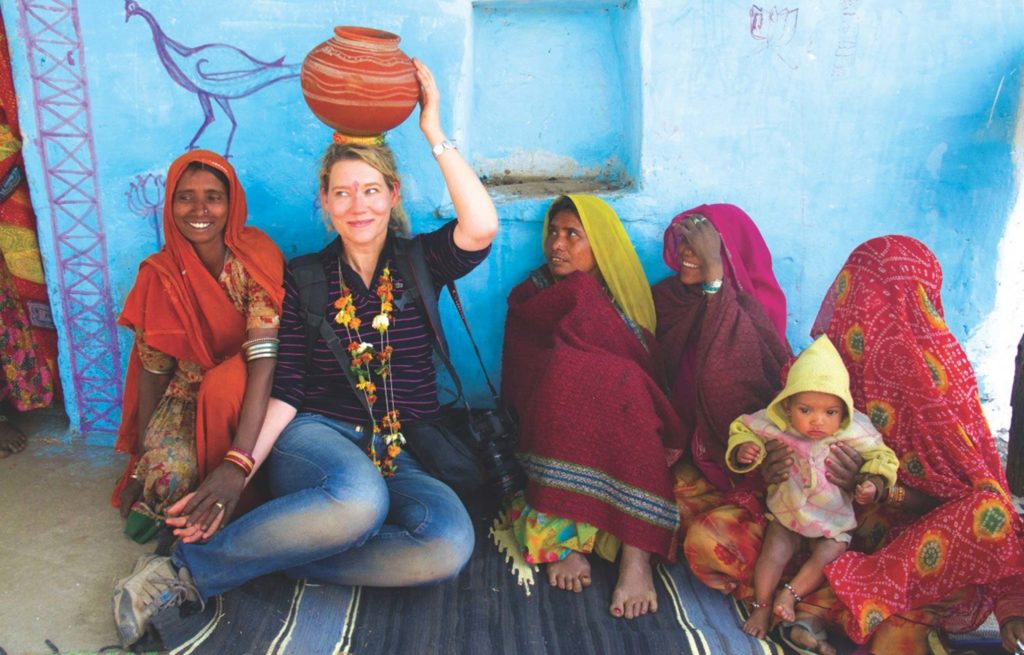 A woman sitting on the ground with a group of people.